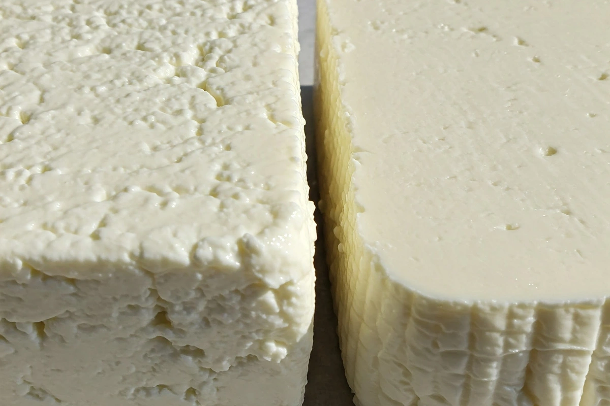 Two styles of feta cheese showing textural differences